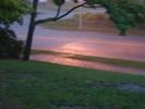 Rains pooling on sidewalk and in the street